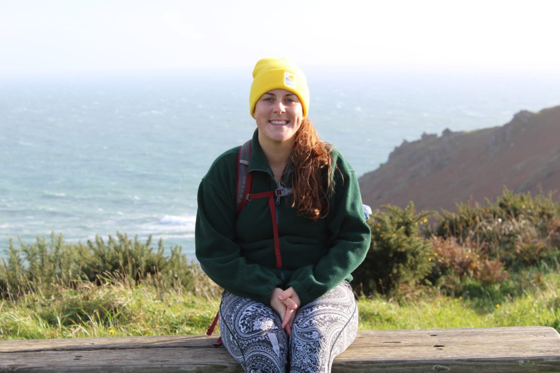 Tash, sat on a bench smiling