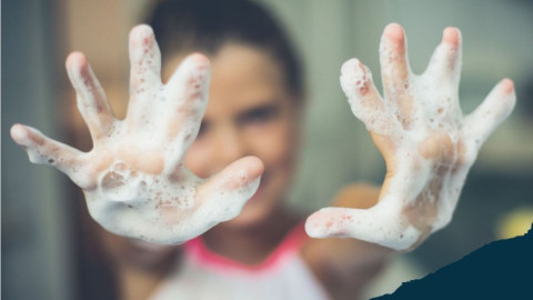 little girl with soap foamed up on hands