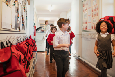 Children running down a school corridor 