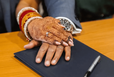 Meena & Gurminder hands overlapping on signing