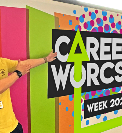 A member of staff highlighting the Careers Worcs Week 2025 sign.
