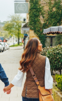 Photograph of a man and woman walking down Broadway High Street