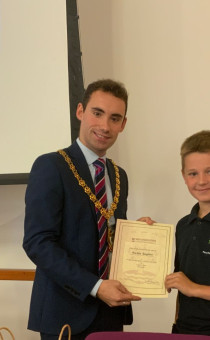 Worcestershire County Council Chairman Kyle Daisley hands a certificate and gift bag to Perryfields Primary PRU pupil Archie Joyner 