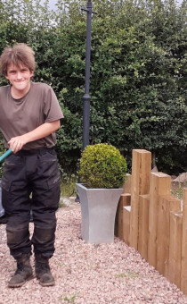 Dan wheeling a wheelbarrow at the Flyford 