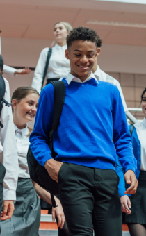 Teenagers in school uniform walking down stairs