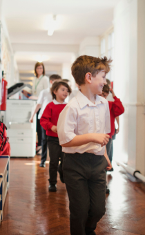 Children running down a school corridor 