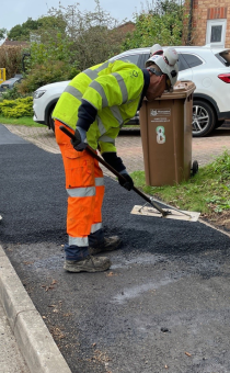 Highway workers repairing a footway