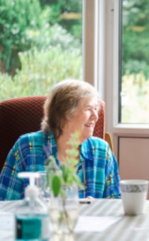 Two adults sitting together on a chair