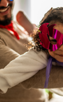 Child and parent dressed as a superhero