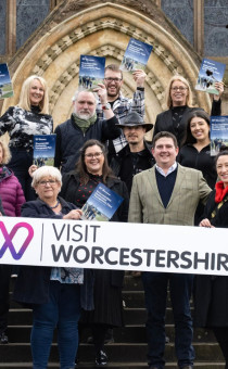 Partners pose with the Destination Management Plan outside Worcester Cathedral