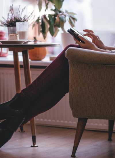 person using a mobile phone sat in a chair