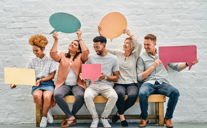 People sat on a bench holding speech bubbles